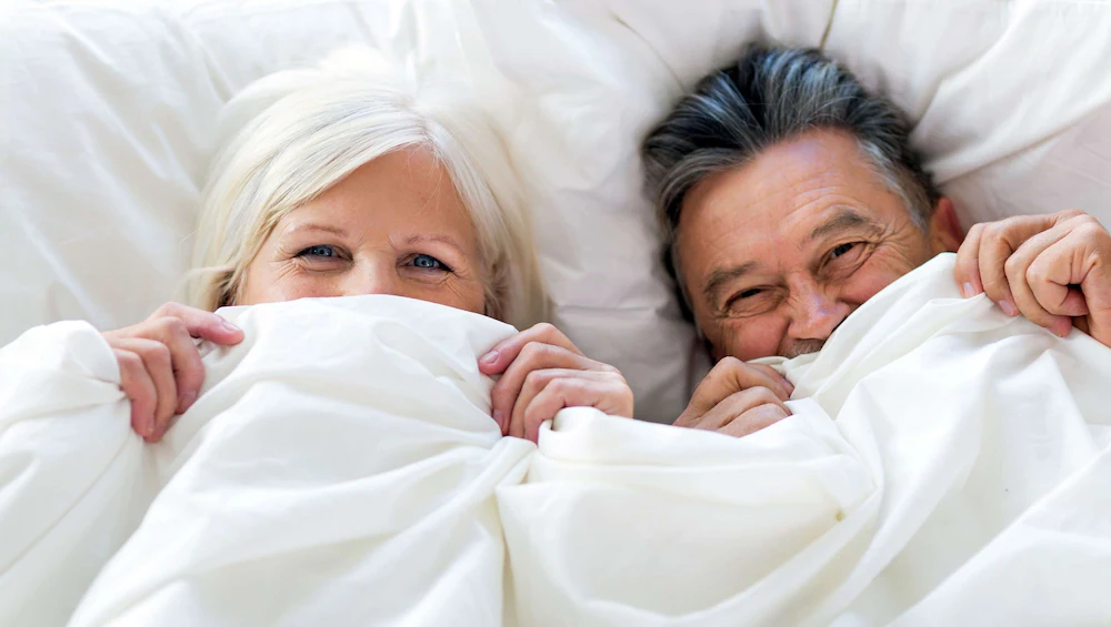 Couple resting comfortably in bed