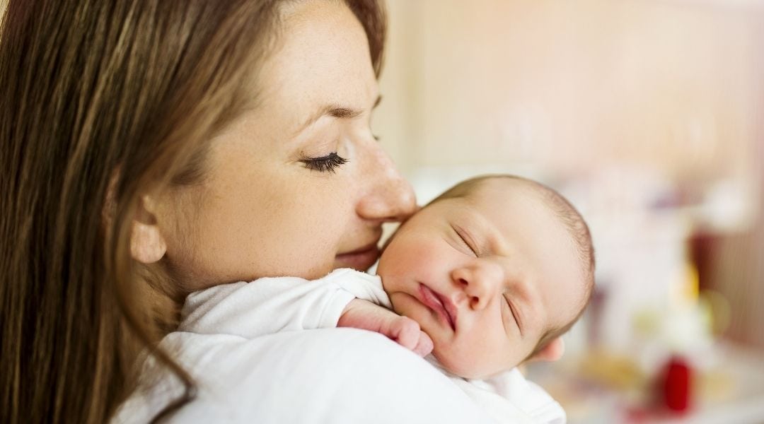 mom holing newborn baby - Are you good to go after your six week checkup?
