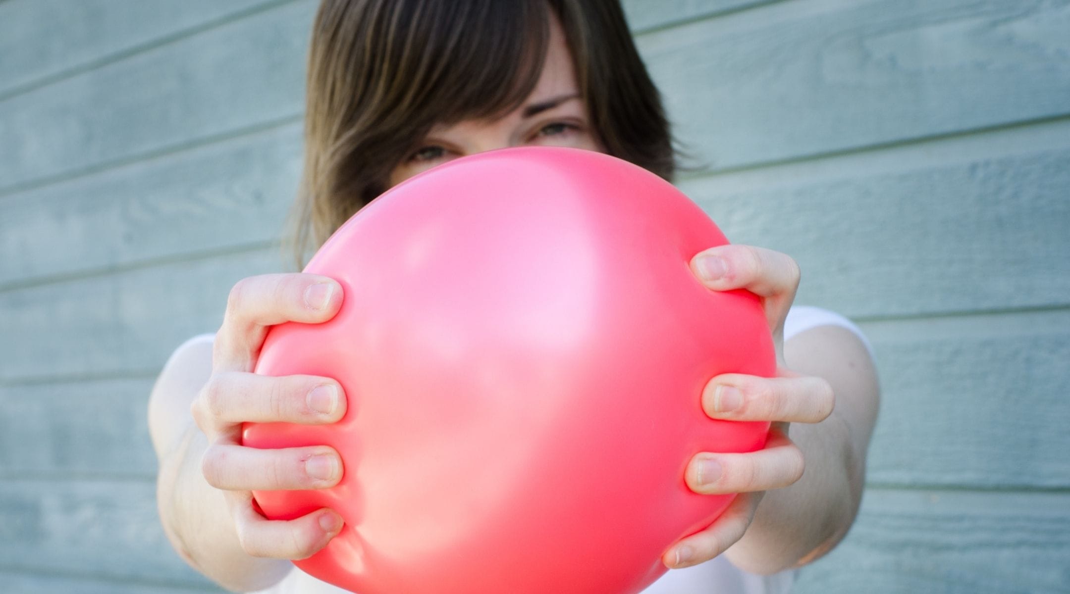 Woman sqeezing a pink baloon - You Can do Better Than Kegels