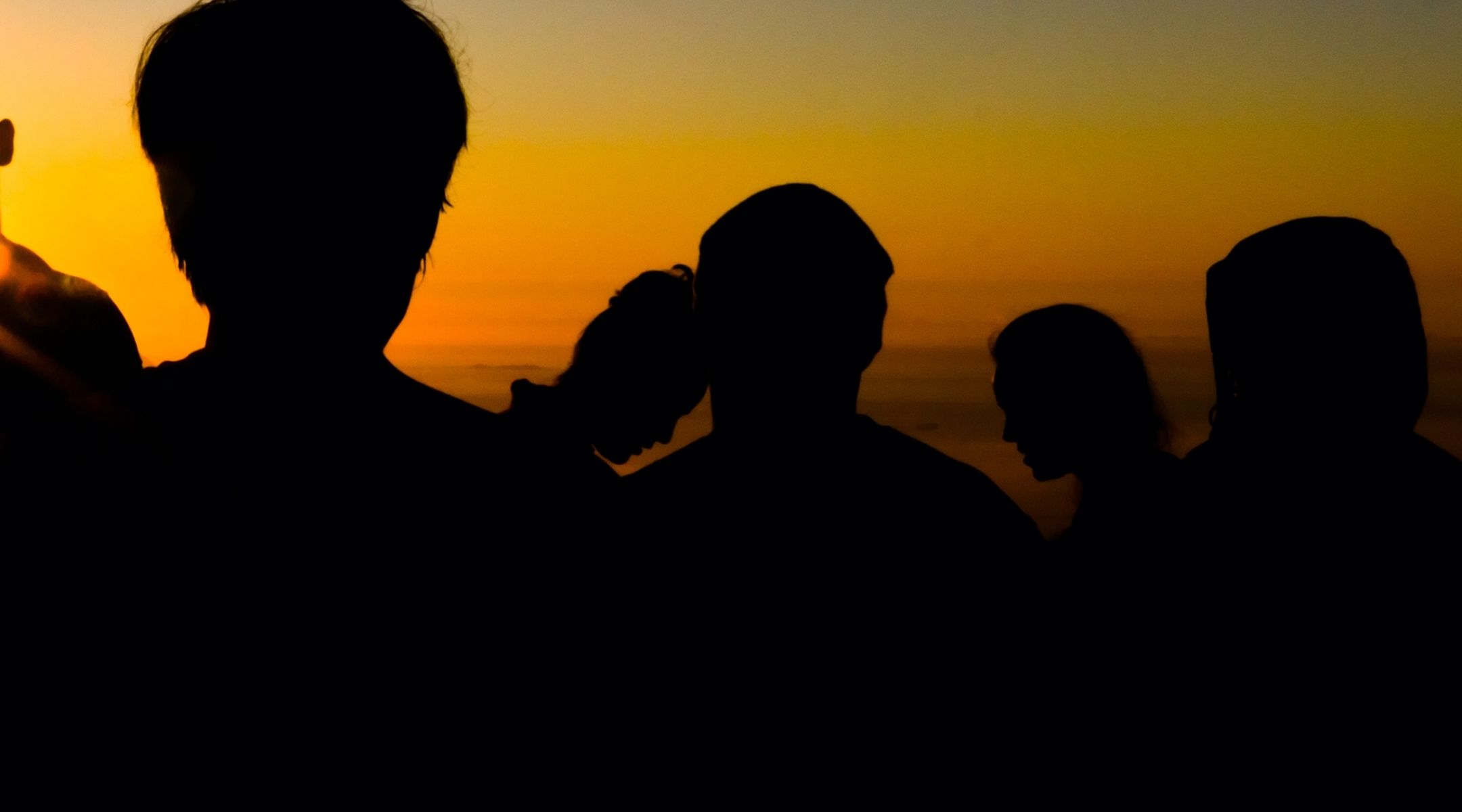 Silhouette of people against a sunset - Who is affected by Diastasis Recti?