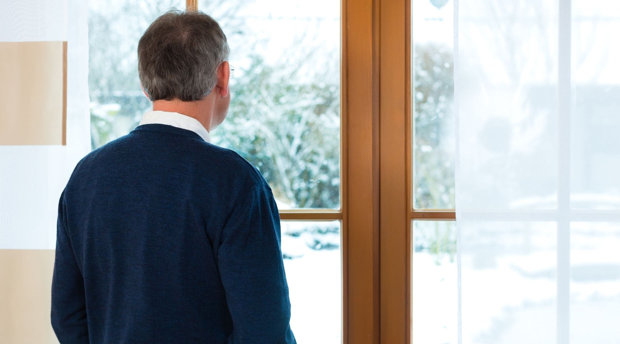 Older man in front of a window staring outside - Depression and anxiety complicate sexual dysfunction